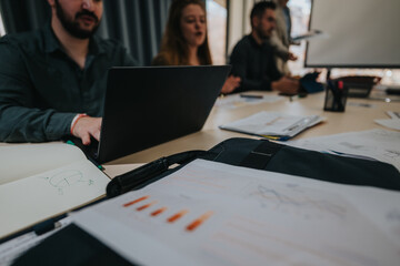 Colleagues working together in a contemporary office environment, discussing strategies and...