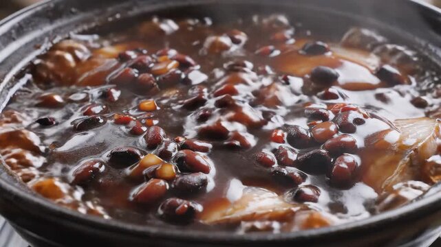 Closeup simmering bean stew bubbling in pot.