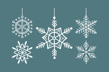Fototapeta premium hanging snowflake ornaments on teal background for winter decoration