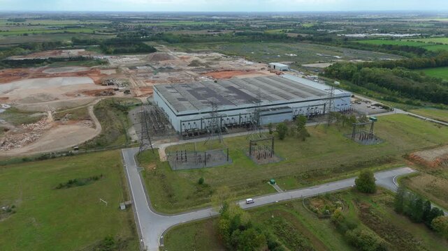 Aerial view of decommissioned power station with its sprawling industrial architecture contrasted by the surrounding lush green fields, Goole, England, United Kingdom.