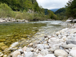 Peaceful Mountain River Flowing Calmly Through Valley
