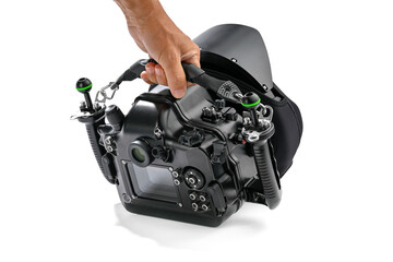 Diver's hand carrying heavy underwater camera housing with lanyard with snap hooks