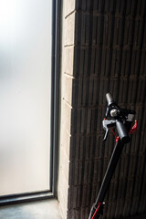 Light from outside the building shines into the part of the electric scooter