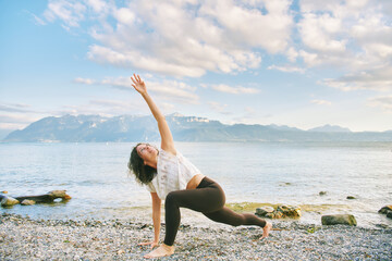 Outdoor portrait of happy candid woman practicing yoga