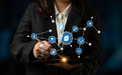 A business professional engages with a digital tablet, illustrating modern technology and data...