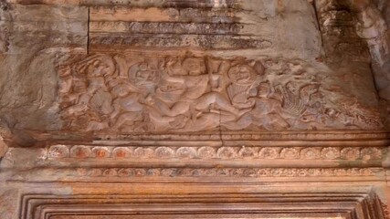 Beautiful ancient stone carvings on the wall of Angkor Wat depicting dancing Apsaras, Cambodia. Shot in motion
