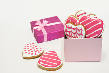 Sweet Valentine's Day Heart cookies and a pink present isolated on white background