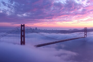 Obraz premium Golden Gate Bridge Covered In Fog. Aerial view of Golden Gate Bridge in clouds during stunning sunset over San Francisco