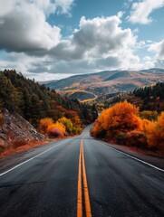 Autumn mountain road winding through vibrant forests under a dramatic sky &mdash; ideal for travel blogs, adventure ads, wallpapers, and destination guides