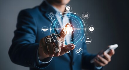 Businessman interacting with a futuristic digital interface displaying icons related to business, technology, and human resources, symbolizing connectivity and data management