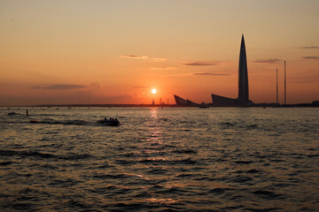A breathtakingly stunning sunset over the water alongside a magnificent city skyline