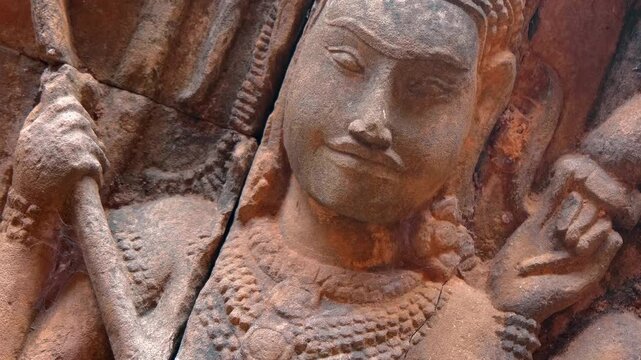 Ancient stone carving of an Apsara along which the ants made a path, Angkor Wat, Cambodia. Closeup
