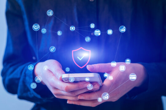 User interacts with mobile device displaying digital security icons in a modern setting - Powered by Adobe