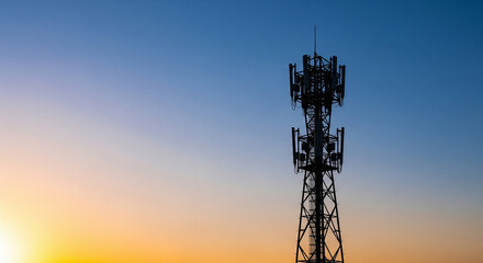 Telecommunication Cell Tower Silhouette Against Vibrant Sunset Sky