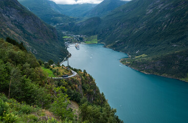 A Ferry boat and small boats on the most beautiful fjord in Norway, Geirangerfjord. Norway