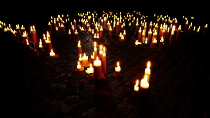 Soft candlelight flickers gently in the darkness, creating a warm glow at a solemn memorial site. People gather to pay their respects, surrounded by the peaceful ambiance offered by the flames.