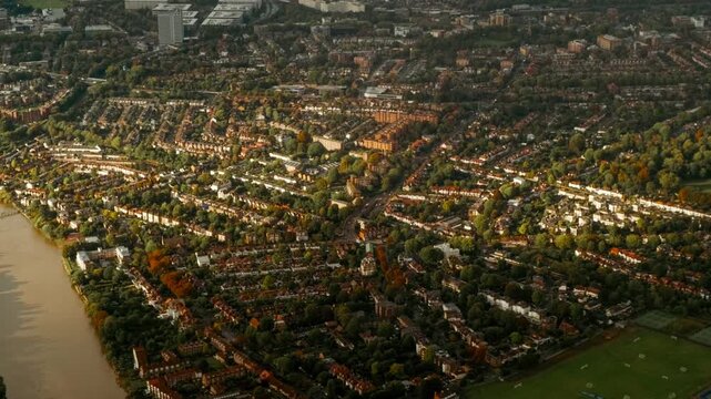 Epic aerial shot of West London, England, UK featuring river Thames, National Archives and Kew Gardens bathed by a glorious sunset