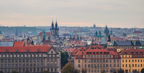 Fototapeta premium Prague Historic Cityscape Church Spires Terracotta Rooftops Urban Architecture Czech Republic Skyline Aerial View Panorama Sunset