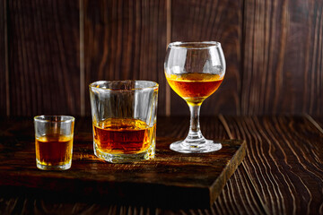 Strong alcohol drink. Whisky in glass, Whisky, bourbon or cognac. Hard strong alcoholic drinkIn various glass forms