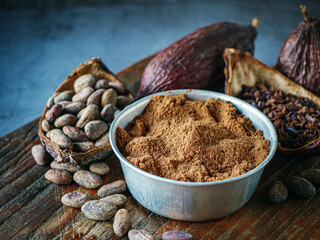 Close-up of Natural cocoa powder with brown cocoa beans and dry cacao nibs