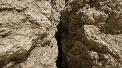 Sunlight filters into a tight crevice formed by towering rock walls. Dust dances in the warm air as the rugged landscape reveals hidden paths waiting to be discovered.