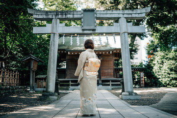 Woman Wearing Kimono Standing in Front of a Shinto Shrine Torii Gate in Tokyo, Japan