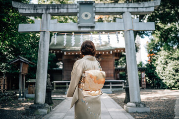 Woman Wearing Kimono Standing in Front of a Shinto Shrine Torii Gate in Tokyo, Japan