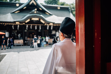 Shinto Priest at Tokyo Shrine Entrance – Traditional Japanese Culture and Architecture