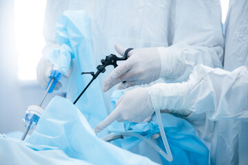 Surgeons performing laparoscopic surgery in operating room with precision