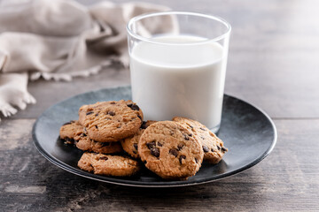 Chocolate chip cookies and milk for breakfast on rustic wooden table