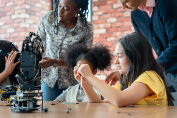 Diverse Students Building and Learning Robotics in STEM Class, Kids and Instructors Working on Mechanical Engineering Project, Children Engaged in Technology and Science Workshop