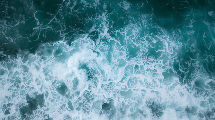 Fototapeta premium Stunning aerial view of dynamic turquoise ocean waves crashing with white foam creating mesmerizing natural patterns