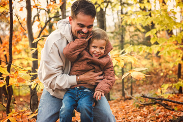 Fototapeta premium father with little boy in autumn beautiful forest