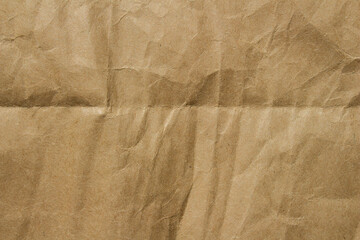 Brown crumpled kraft paper texture with deep folds and creases