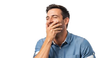 Man in a light blue shirt is overcome with laughter, covering his mouth with his hand, eyes closed in mirthful expression.  