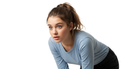 Focused young woman with ponytail, wearing a light blue top, looking intently ahead with anticipation and alertness.