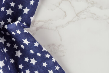 Obraz premium Star Pattern Fabric On Marble Surface With Copy Space