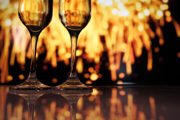 Fireworks illuminate victorious toast moment, Celebratory scene with champagne flutes and fireworks