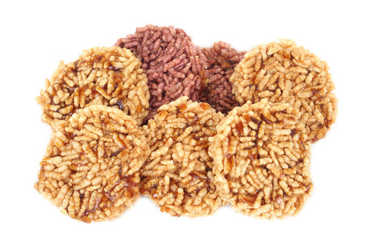 Close up of traditional Thai crispy rice crackers topped with sweet caramel syrup. Delicious local snack made from puffed rice, showcasing Thai dessert culture and homemade traditional taste.