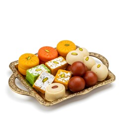 Assorted Indian sweets served on an ornate tray