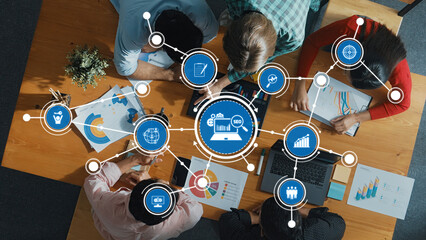 Aerial view of a business meeting showcasing professionals engaged in data analysis and brainstorming. Charts and technology highlight SEO and marketing strategies for growth. Amity