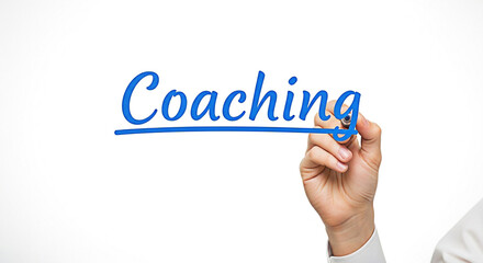 Hand writing the word coaching in blue marker on a clear surface for business development and personal growth concepts and applications