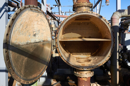 Industrial heat exchanger or boiler tubes bundle. Two way heat exchanger shell and tubes opened for repairing and deposits cleaning at petrochemical enterprises industrial background with copy space.