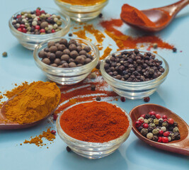 Orange paprika in bowl on blue background. Food seasoning texture. Seasonings vibe.