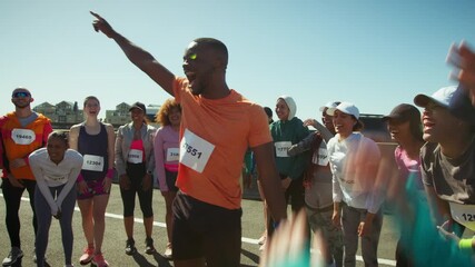 A group of cheerful runners huddle, celebrating their shared passion for fitness and camaraderie. They raise their arms in excitement, ready for the challenge ahead.