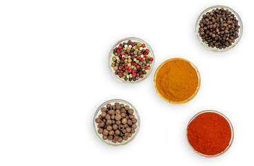 Top view of spice composition in bowls. Colorful Indian and Asian seasonings on white.