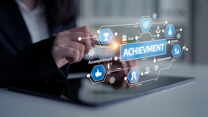 A professional setting features a person interacting with a tablet displaying icons related to achievement and success, symbolizing personal and business growth. Tessel