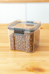 Filled coffee plastic containers on the kitchen background