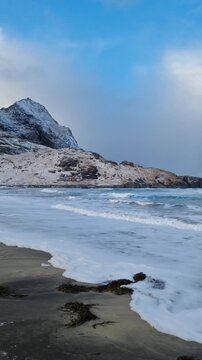 Scenic view of the winter  landscapes at Bunes Beach on a  with the mountains in the background on Lofoten Islands in Norway.

