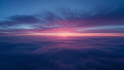 Fototapeta premium Stretching cloud layer glowing soft purple and pink during sunrise from aerial vantage, sun glow
